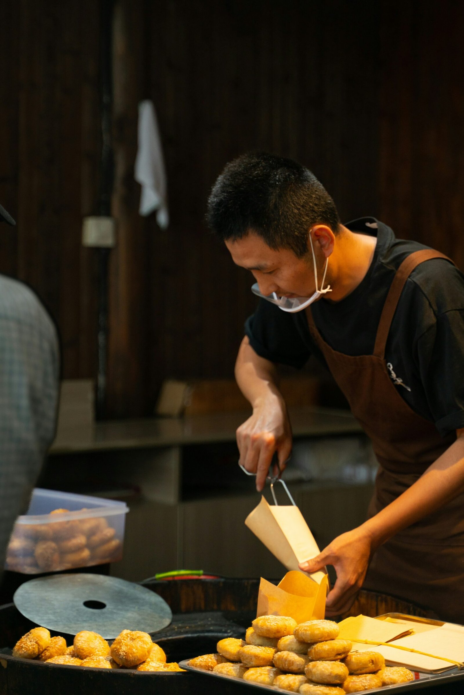 A man preparing food on a grill in a kitchen